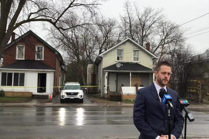 Detective sergeant Josh McGrath of the major crimes unit of the Peterborough Police Service speaks at a media briefing on April 21, 2022 across the street from a home at 124 Park Street South, where two Mississauga were shot the previous afternoon, with one later dying in hospital from his injuries. (kawarthaNOW screenshot of Peterborough Police Service video)