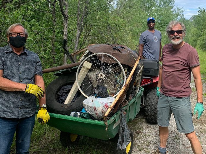 Kawartha Rotarians Gord Fallen, Wesley Letsholo, and Guenther Schubert participating in a clean-up along the Jackson Park trail in 2021. (Photo courtesy of Rotary Club of Peterborough Kawartha)