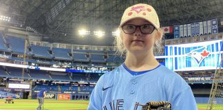 Sarah Patterson, a Grade 4 student with Down Syndrome at St. Anthony Catholic Elementary School in Port Hope, preparing to throw the ceremonial pitch at the Blue Jays game at the Rogers Centre in Toronto on April 25, 2022. Sarah was recognized for her participation in the Jays Care Foundation affiliate school program, which her teacher Allison Jacques ran from February to April. (Photo: Jays Care Foundation / Twitter)