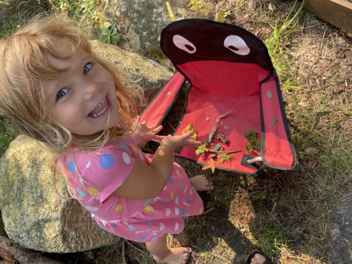 With its "Camp to Cottage" program, The Land Canadian Adventures brings the forest school experience directly to the family cottage, engaging kids in the natural world right in their own backyard. Here, Camp-to-Cottage camper Avery shows off her collection of natural materials, including cedar, pinecones, stones, and maybe a bit of goldenrod.   (Photo courtesy of The Land Canadian Adventures)