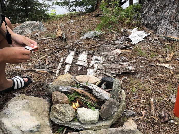 Through The Land Canadian Adventures' "Camp to Cottage" program, kids can connect with nature, learn how to canoe, and explore wilderness living and bushcraft skills, including how to safely build a fire.  (Photo courtesy of The Land Canadian Adventures)