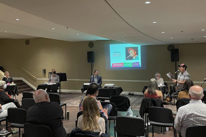 Poet Ziysah von Bieberstein, who was also one of the debate moderators, performed their poem "Stop the Cuts" during Artsvote Ontario 2022 in the Nexicom Studio at Showplace Performance Centre on Thursday, May 26. (Photo: Justin Sutton / kawarthaNOW)