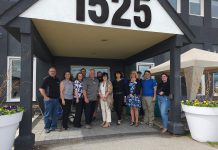 At The Lake Distributing owners Jason Pulchinski (front row, fourth from left) and Niki Pulchinski (front row, third from right) with their employees at their building at 1525 Chemong Road just outside Peterborough. As well as expanding their recreational water product wholesale distribution business thanks to a grant and support from Community Futures Peterborough, Jason and Niki have launched Shop The Lake, a patio furniture business also located in the building. (Photo courtesy of At The Lake Distributing)