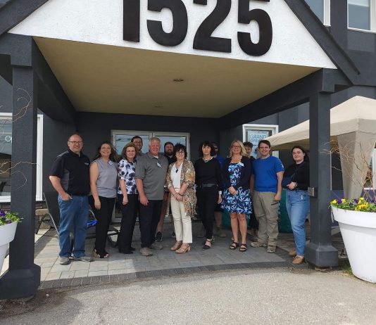 At The Lake Distributing owners Jason Pulchinski (front row, fourth from left) and Niki Pulchinski (front row, third from right) with their employees at their building at 1525 Chemong Road just outside Peterborough. As well as expanding their recreational water product wholesale distribution business thanks to a grant and support from Community Futures Peterborough, Jason and Niki have launched Shop The Lake, a patio furniture business also located in the building. (Photo courtesy of At The Lake Distributing)