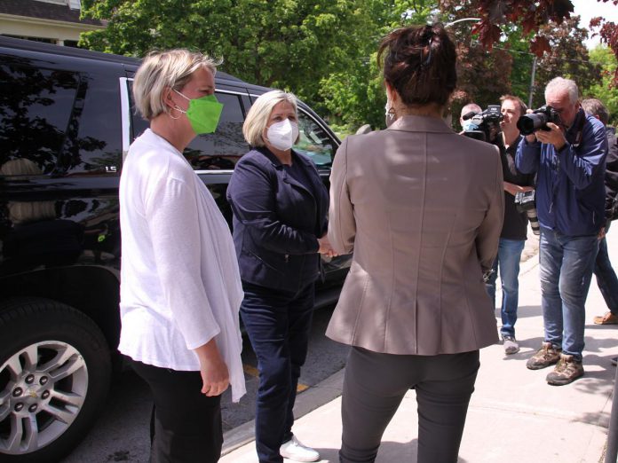 Surrounded by local media, Ontario NDP leader Andrea Horwath (middle) speaks with Peterborough-Kawartha NDP candidate Jen Deck (left) and Peterborough mayor Diane Therrien (with her back to the camera) just after Horwath arrived outside Immaculate Conception Catholic Elementary School in Peterborough's East City on May 25, 2022 to survey some of the damage caused by the devastating wind storm on the Victoria Day long weekend. (Photo: Jeannine Taylor / kawarthaNOW