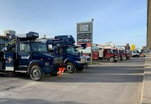 Around 15 hydro trucks from other jurisdictions parked outside Smitty's in downtown Peterborough on May 25, 2022, while their crews got breakfast before another day assisting Hydro One in restoring power. (Photo: Brian Parypa)