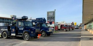 Around 15 hydro trucks from other jurisdictions parked outside Smitty's in downtown Peterborough on May 25, 2022, while their crews got breakfast before another day assisting Hydro One in restoring power. (Photo: Brian Parypa)
