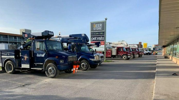 Around 15 hydro trucks from other jurisdictions parked outside Smitty's in downtown Peterborough on May 25, 2022, while their crews got breakfast before another day assisting Hydro One in restoring power. (Photo: Brian Parypa)