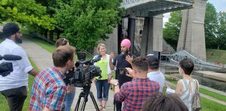 Federal NDP leader Jagmeet Singh, with provincial Peterborough-Kawartha NDP candidate Jen Deck beside him, answers questions during a media conference beside the Peterborough Lift Lock on May 31, 2022. (Photo: Jeannine Taylor / kawarthaNOW)