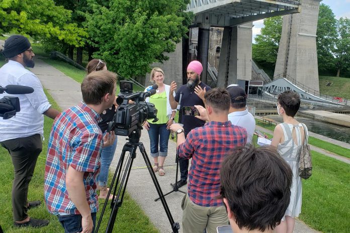 Federal NDP leader Jagmeet Singh, with provincial Peterborough-Kawartha NDP candidate Jen Deck beside him, answers questions during a media conference beside the Peterborough Lift Lock on May 31, 2022. (Photo: Jeannine Taylor / kawarthaNOW)