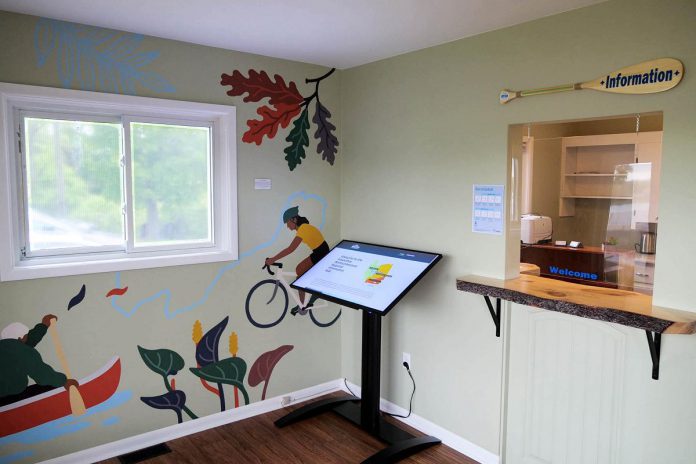 The seasonal Kawarthas Northumberland Visitor Centre will be staffed by full-time student travel counsellors and features a new state-of-the art digital kiosk. Also pictured is a mural by Indigenous artist Caitlin Taguibao. (Photo courtesy of RTO8)