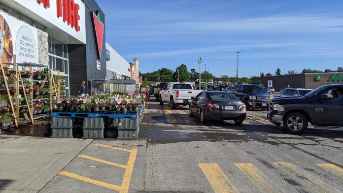 Vehicles lined up outside the Canadian Tire location on Lansdowne Street in Peterborough to pick up purchased generators early in the morning of May 23, 2022. (Photo: Bruce Head / kawarthaNOW)