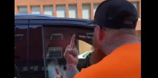 Two protestors give federal NDP leader Jagmeet Singh the finger while yelling abusive comments as the politician got into his vehicle following a stop at provincial NDP candidate Jen Deck's campaign office in downtown Peterborough on May 10, 2022. (Screenshot of Facebook video)
