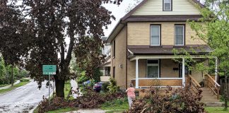 A resident in Peterborough's East City cleans up fallen branches and brush after the severe storm on May 21, 2022. (Photo: Bruce Head / kawarthaNOW)