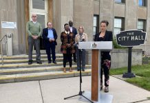 Mayor Diane Therrien delivers a statement on behalf of Peterborough city council outside city hall on May 17, 2022, in which she condemned the behaviour of protestors during federal NDP leader Jagmeet Singh's visit to Peterborough the previoius week. Also pictured are city councillors Henry Clarke, Keith Riel, Kemi Akapo, Stephen Wright, and Kim Zippel. (Photo: Paul Rellinger / kawarthaNOW)