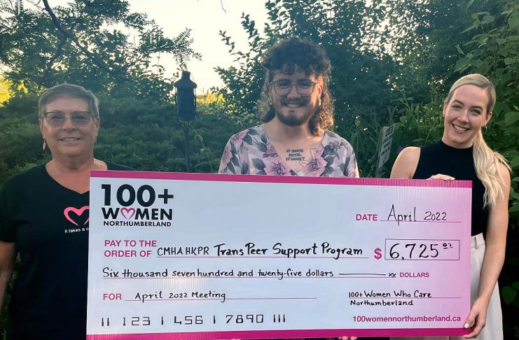 Carl Cruise-Baxter (middle), an outreach worker with the Canadian Mental Health Association Haliburton, Kawartha, Pine Ridge's Trans Peer Outreach program, accepts a donation of $6,725 from members of 100 Women of Northumberland. (Photo courtesy of CMHA HKPR)