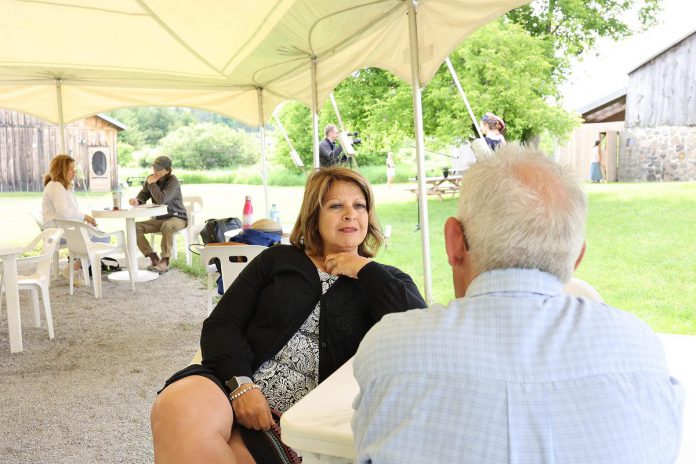 4th Line's managing artistic director Kim Blackwell speaks with with kawarthaNOW's Paul Rellinger about "The Great Shadow" during a media event at 4th Line Theatre's Winslow Farm in Millbrook on June 15, 2022. (Photo: Heather Doughty / kawarthaNOW)