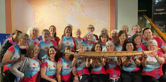 Members of Dragons Abreast, the first breast cancer survivor dragon boat team in Toronto and one of the first in the world, with the five-foot model of a dragon boat they donated to The Canadian Canoe Museum in Peterborough on June 15, 2022. The model is a scale replica of the dragon boat built in 2008 by the Avalon Dragons, Newfoundland and Labrador's first breast cancer survivor dragon boat team. (Photo: The Canadian Canoe Museum / Facebook)