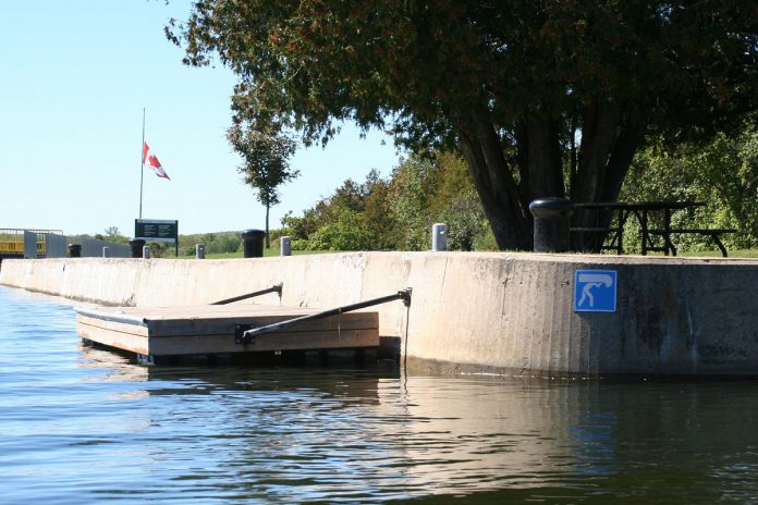 A canoe portaging dock near a lock along the Trent-Severn Waterway. The Canadian flag is at half-mast recognizing the confirmation of unmarked graves at Indian Residential Schools during the summer of 2021. (Photo: Jenn McCallum)
