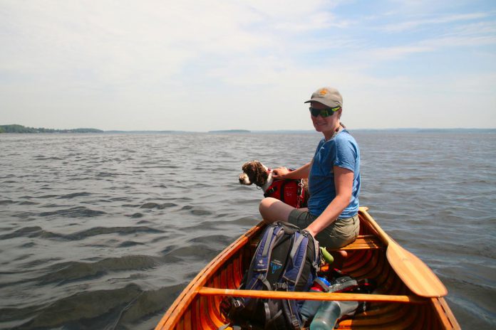 Jenn McCallum with her dog Blitz on Rice Lake on June 6, 2021, during a paddling trip a group of 16 friends from Peterborough took along the Trent-Severn Waterway from the Otonabee River in the south Peterborough to the Bay of Quinte. (Photo: Taylor Wilkes)