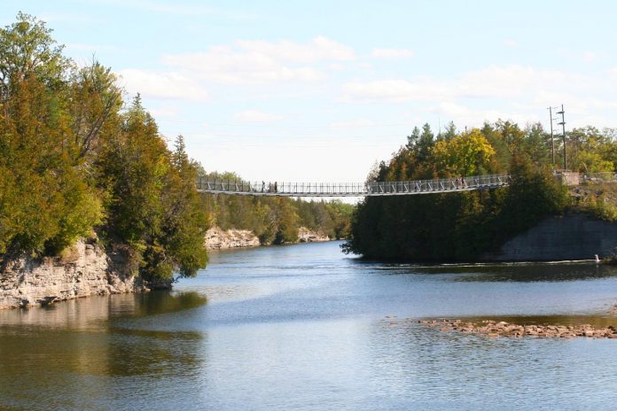The Ranney Gorge suspension bridge along the Trent River is recognized as Ontario's most scenic suspension bridge, and paddlers can also enjoy views of the cliffs from underneath the bridge. (Photo: Jenn McCallum)
