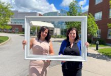 Michelle Finley, a district manager with Kawartha Credit Union, and Erin Coons, CEO of the Ross Memorial Hospital Foundation, in front of the Lindsay hospital. (Photo courtesy of RMH Foundation)