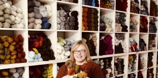 Owner Deanna Guttman pictured in 2019 in front of her wall of yarn at Needles in the Hay in downtown Peterborough, one of seven yarn shops participating in this year's Cottage Country Yarn Crawl running from June 11 to September 6, 2022. (Photo: Amy E. LeClair)