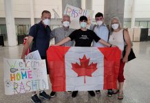 Rashid, an 18-year-old Syrian refugee separated from his family who had been living in Turkey under fear of deportation, holds a Canadian flag after he arrived at Toronto's Pearson International Airport on June 23, 2022, where he was welcomed to his new home by his sponsors (left to right) Michael VanDerHerberg, Dave McNab, Matt Park, and Kristy Hiltz. (Photo courtesy of Dave McNab)