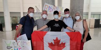 Rashid, an 18-year-old Syrian refugee separated from his family who had been living in Turkey under fear of deportation, holds a Canadian flag after he arrived at Toronto's Pearson International Airport on June 23, 2022, where he was welcomed to his new home by his sponsors (left to right) Michael VanDerHerberg, Dave McNab, Matt Park, and Kristy Hiltz. (Photo courtesy of Dave McNab)