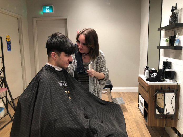 Rashid gets a haircut after arriving to his new home in Canada. (Photo courtesy of Dave McNab)