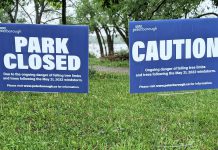 Signage at Roger's Cove in Peterborough's East City on June 1, 2022 advising the park is closed due to the danger of falling limbs from trees damaged by the May 21st wind storm. (Photo: Bruce Head / kawarthaNOW)