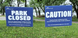 Signage at Roger's Cove in Peterborough's East City on June 1, 2022 advising the park is closed due to the danger of falling limbs from trees damaged by the May 21st wind storm. (Photo: Bruce Head / kawarthaNOW)