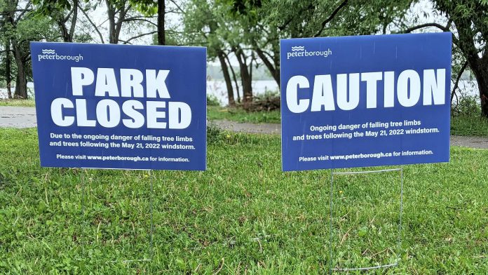 Signage at Roger's Cove in Peterborough's East City on June 1, 2022 advising the park is closed due to the danger of falling limbs from trees damaged by the May 21st wind storm. (Photo: Bruce Head / kawarthaNOW)