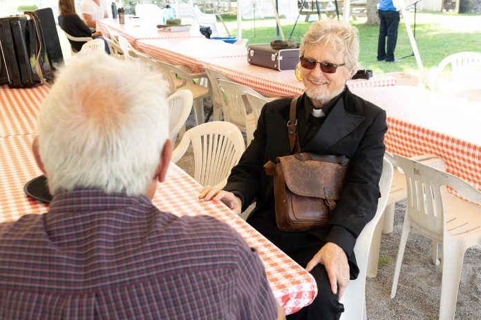 4th Line Theatre founder Robert Winslow, who plays preacher Thaddeus Lewis in "Wishful Seeing," speaks with kawarthaNOW's Paul Rellinger during a media event for the play at 4th Line Theatre's Winslow Farm in Millbrook on July 20, 2022. (Photo: Heather Doughty / kawarthaNOW)