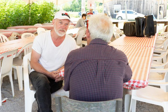 JD (Jack) Nicholsen,  who plays George Howell in 4th Line Theatre's production of "Wishful Seeing," speaks with kawarthaNOW's Paul Rellinger during a media event for the play at 4th Line Theatre's Winslow Farm in Millbrook on July 20, 2022. (Photo: Heather Doughty / kawarthaNOW)