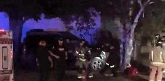 The driver of this vehicle that crashed into a tree on the front lawn of a Peterborough home on July 28, 2022 is facing multiple charges. (kawarthaNOW screenshot of video by David Post / Twitter)