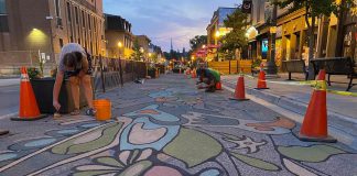 Nuin-Tara Morin (Stardaughterwoman) and assistant Chris Boyd wrapping up the road mural "Nothing Out of Reach" on Sunday, July 17 as part of the City of Peterborough's 2022 Renaissance on Hunter initiative. (Photo: City of Peterborough Public Art Program / Facebook)