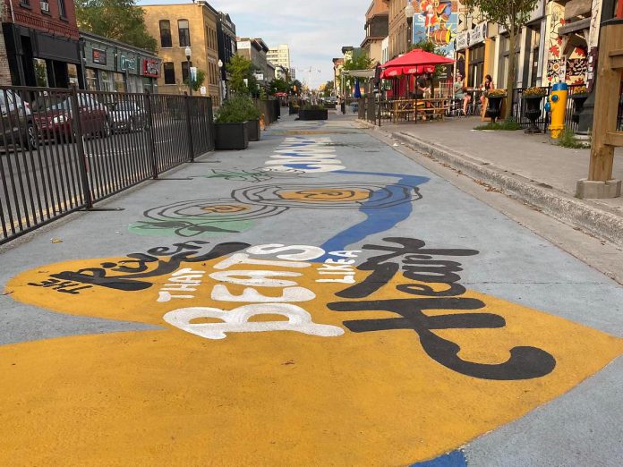 The "Odoonabii" road mural by Aaron Robitaille was completed on Monday, July 18 as part of the City of Peterborough's 2022 Renaissance on Hunter initiative.  (Photo: City of Peterborough Public Art Program / Facebook)