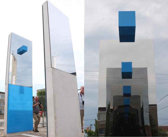 The UN Peacekeepers Monument in Peterborough's new urban park features two 14-foot mirrored sculptures with a blue square embedded at the top of each. This creates a "hall of mirrors" effect when an observer stands between them, with blue dotted line (representing the borders between countries) appearing to float in the air. (Photos courtesy of Sean Bruce)