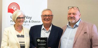 Jim Russell (right), CEO of United Way of Peterborough & District, presented the organization's 2022 Scholfield Award of Community Distinction to Katie and Jim Stewart of the Township of Otonabee South Monaghan on August 23, 2022. (Photo courtesy of United Way of Peterborough & District)