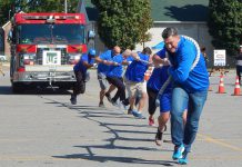 A determined Team RBC pulls a fire truck during a previous Pulling for Dementia Fire Truck Pull event. In this annual fundraiser for Alzheimer Society of Peterborough, Kawartha Lakes, Northumberland and Haliburton, teams of 10 to 12 people compete to pull a 44,000-pound fire truck the greatest distance in the least amount of time. The 2022 event takes place on Wednesday, September 21 at the Peterborough Airport. (Photo: Alzheimer Society of PKLNH)