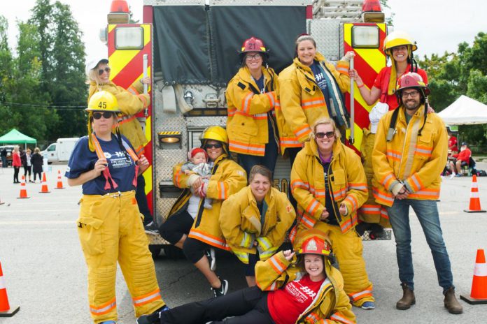 Dementia Defenders, a team comprised of staff of Alzheimer Society of Peterborough, Kawartha Lakes, Northumberland and Haliburton, pose in front of the fire truck during a previous Pulling for Dementia Fire Truck Pull event. (Photo: Alzheimer Society of PKLNH)