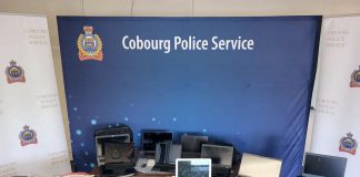 Some of the $38,000 worth of stolen laptops and tablets, government-issued identification cards, cheques, and banking and tax documents Cobourg police recovered from the vehicle of a 30-year-old Cobourg man, who faces 42 charges with more charges pending. (Police-supplied photo)