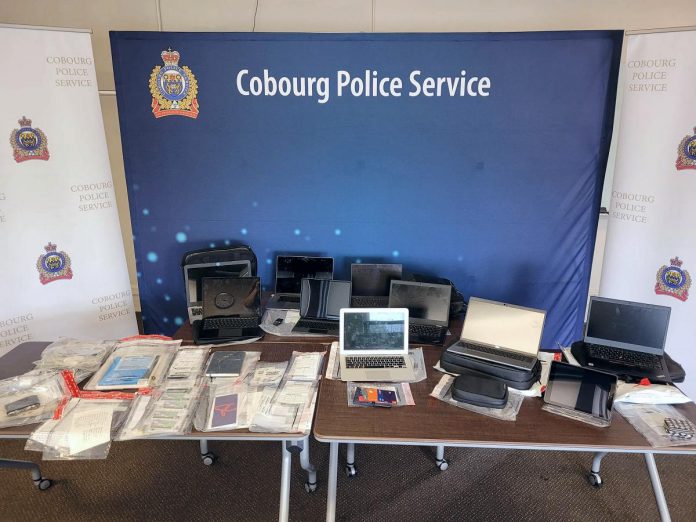 Some of the $38,000 worth of stolen laptops and tablets, government-issued identification cards, checks, and banking and tax documents Cobourg police recovered from the vehicle of a 30-year-old Cobourg man, who faces 42 charges with more charges pending.  (Police-supplied photo)