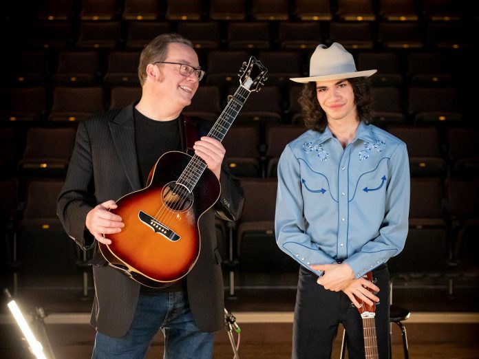 Rick Fines and Nicholas Campbell are two of the Peterborough-area musicians featured on "Cover2Cover," a four-episode series on Bell Fibe TV1 directed by Michael Hurcomb where a well-known local musician covers a song by an up-and-coming local musician and vice versa. In episode four, Fines performs a cover of Campbell's song "Livin'" and Campbell performs a cover of Fines' song "Try a Little Harder." Hosted by Kate Suhr, the series was filmed at at Market Hall Performing Arts Centre in downtown Peterborough. (Photo: Michael Hurcomb)