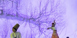 Mayez Rahman as the whirling dervish and Carolina Loyola-Garcia as the flamenco dancer in "Digital Dervish and Flamenco Sonic", a multimedia dance performance presented by Public Energy Performing Arts at the Market Hall in Peterborough on September 9 and 10, 2022. Created by Hedy Hurban of the U.K. artistic company Firoza, the work combines original digital projections, live performance, and wearable technology. Hurban's partner Kaz Rahman, the visual artist and filmmaker who created the digital projections for the production, grew up in Peterborough. (Photo: Lloyd Russell)