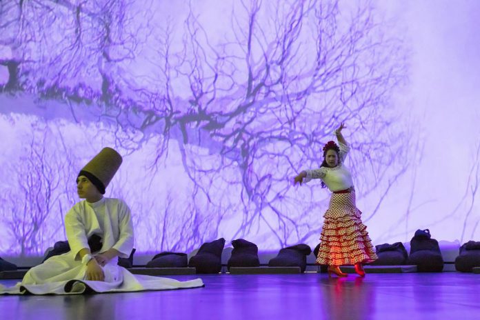 Mayez Rahman as the whirling dervish and Carolina Loyola-Garcia as the flamenco dancer in "Digital Dervish and Flamenco Sonic", a multimedia dance performance presented by Public Energy Performing Arts at the Market Hall in Peterborough on September 9 and 10, 2022. Created by Hedy Hurban of the U.K. artistic company Firoza, the work combines original digital projections, live performance, and wearable technology. Hurban's partner Kaz Rahman, the visual artist and filmmaker who created the digital projections for the production, grew up in Peterborough. (Photo: Lloyd Russell)