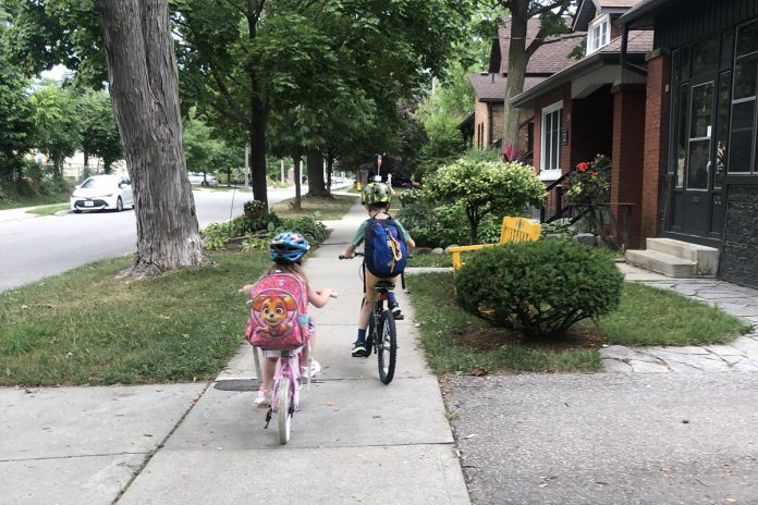 James and his sister ride to school in the morning because it's fun and fast. They take special care while riding on sidewalks, watching for driveways, pedestrians, and pups. (Photo: C. Roberts)