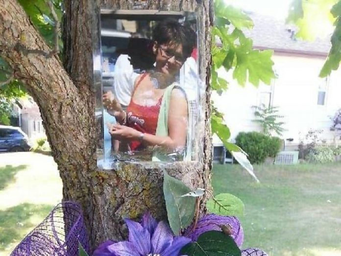 Outside of her Peterborough home, Gail Parry displays a photo of her late daughter Jody each August, the month she passed away from health issues related to her substance use. Parry is a member of Moms Stop The Harm, a network of Canadian families that advocates for change as that pertains to failed substance use strategies and policies, and is the key organizer of local events associated with International Overdose Awareness Day held annually on August 31. (Photo courtesy of Gail Parry)