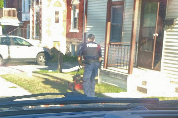 A Peterborough police officer, since identified as Constable Brandon Bigelow, recently cut the lawn of a 76-year-old resident who was upset about being unable to do so because of a medical procedure. (Photo via Peterborough Police Service / Facebook)